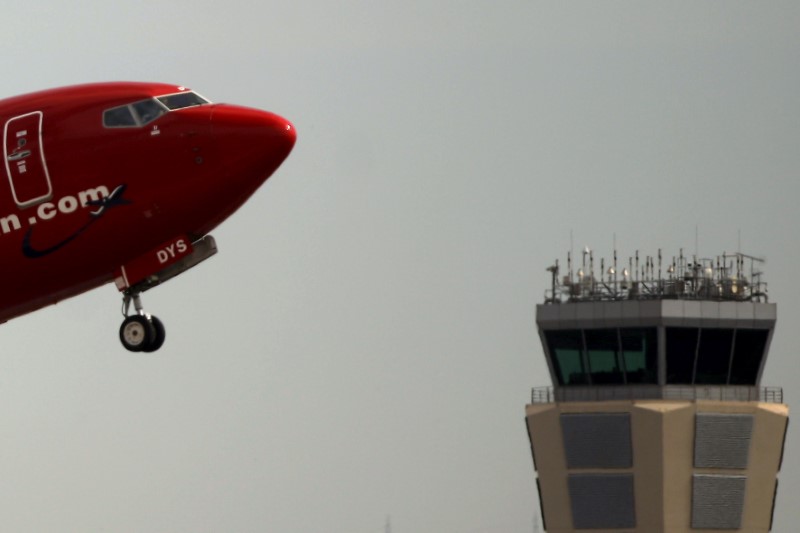 © Reuters. FILE PHOTO: Norwegian aircraft takes off past the air traffic control tower of Pablo Ruiz Picasso Airport in Malaga