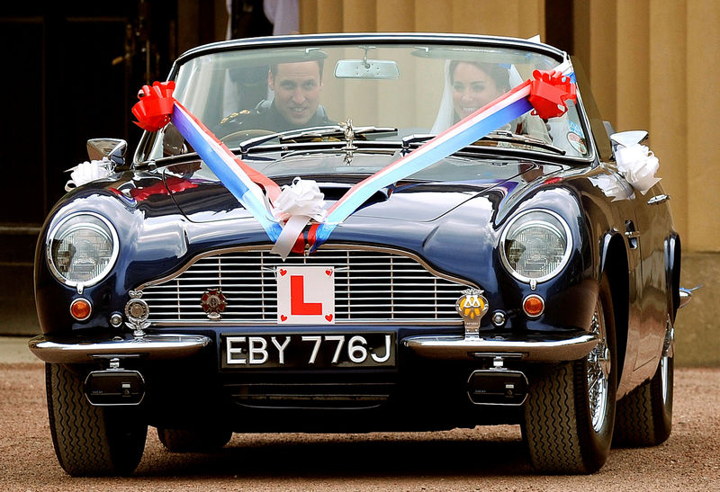 © Reuters. FILE PHOTO - Britain's Prince William and his wife Catherine, Duchess of Cambridge drive from Buckingham Palace in an Aston Martin DB6 Mark 2, after their wedding in Westminster Abbey, in central London, April 2011