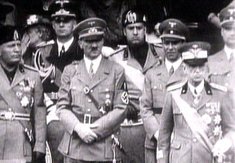 © Reuters. FILE PHOTO: King Victor Emanuel III, Adolf Hitler and Benito Mussolini watch fascist troops march past from a balcony in central Rome in this still image taken from 1941 television file footage