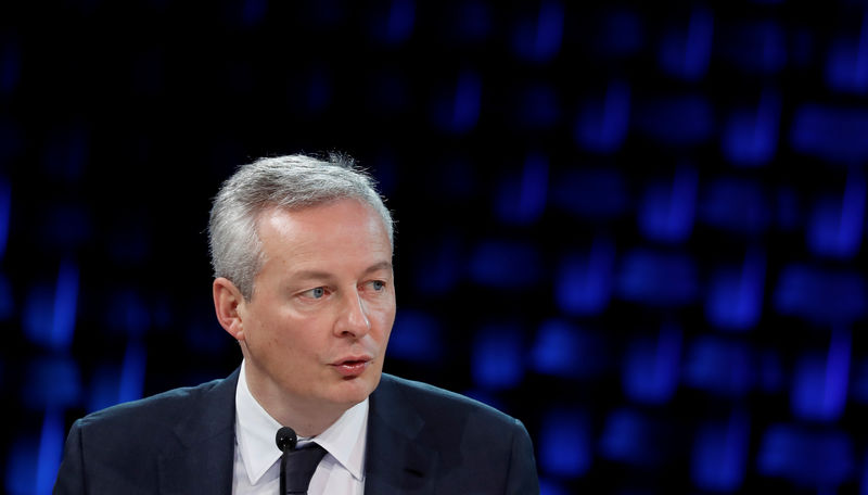 © Reuters. FILE PHOTO - French Finance Minister Bruno Le Maire delivers a speech as he attends a working session during the One Planet Summit at the Seine Musicale center in Boulogne-Billancourt, near Paris