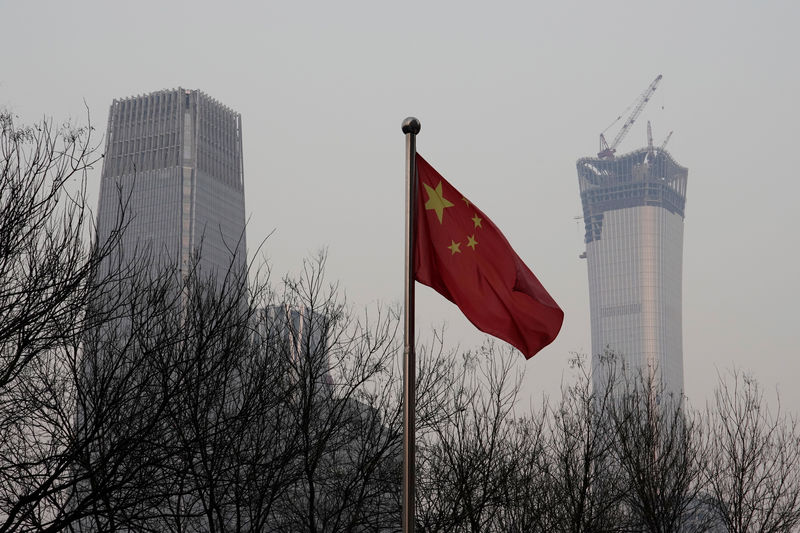 © Reuters. China World Trade Center Tower III and China Zun Tower under construction are pictured behind a Chinese flag in Beijing