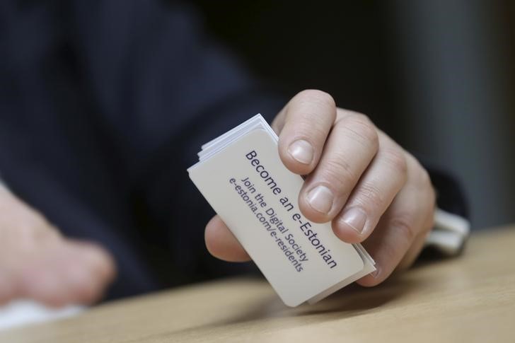 © Reuters. Estonia's government chief information officer Kotka holds cards to promote e-residency in Tallin