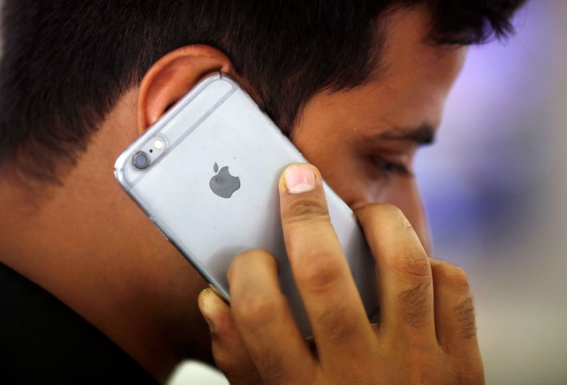 © Reuters. Homem durante ligação com seu iPhone em loja de Nova Délhi, Índia