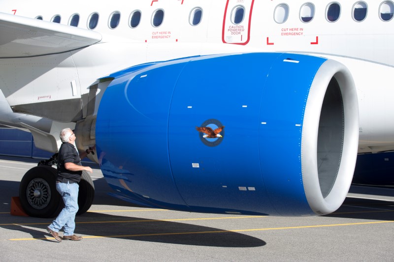 © Reuters. FILE PHOTO: An employee inspects the engine of a C Series plane at Bombardier's plant in Mirabel