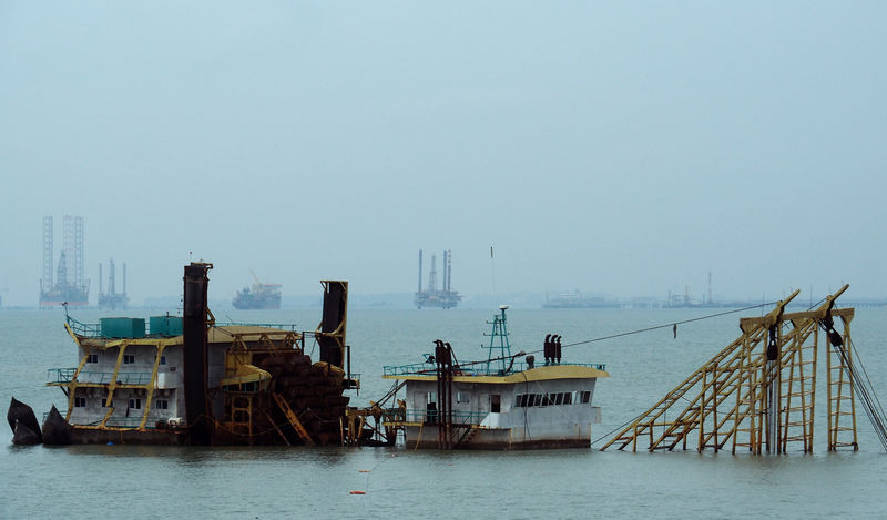 © Reuters. FILE PHOTO: A scrapped vessel sits in the Johor River