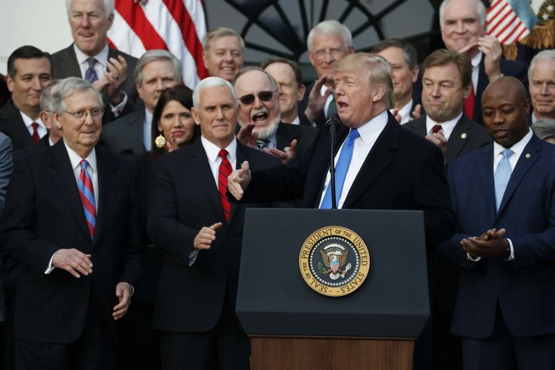 © Reuters. U.S. President Trump celebrates with Congressional Republicans after passage of GOP tax bill at the White House in Washington