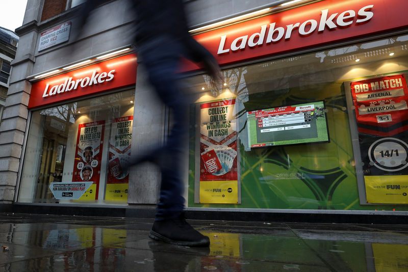 © Reuters. A pedestrian walks past a branch of Ladbrokes in London