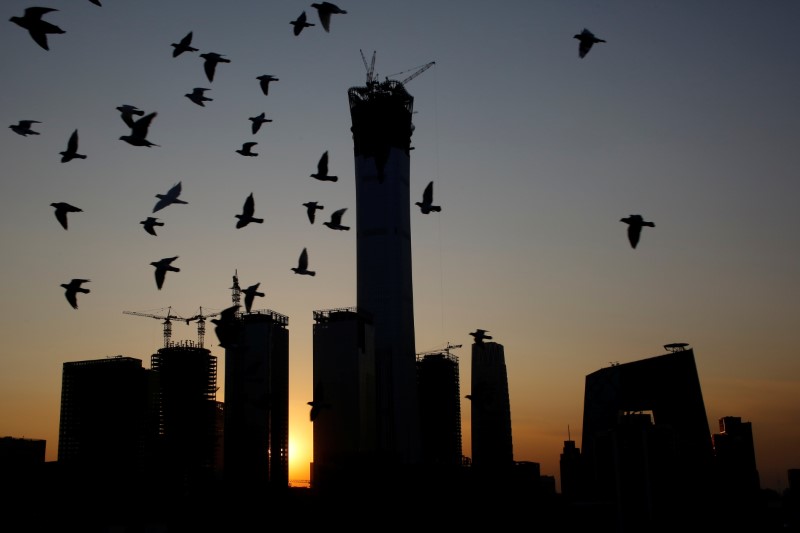 © Reuters. The sun sets behind the Central Business District with the CITIC Tower at it's centre in Beijing