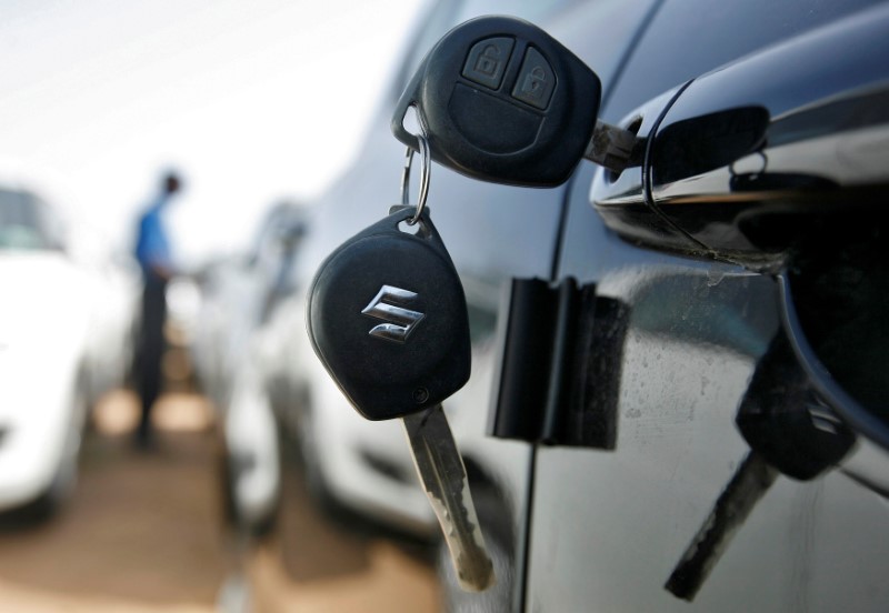 © Reuters. FILE PHOTO: Keys hang from door of Maruti Suzuki Swift car at its stockyard on the outskirts of the western Indian city of Ahmedabad