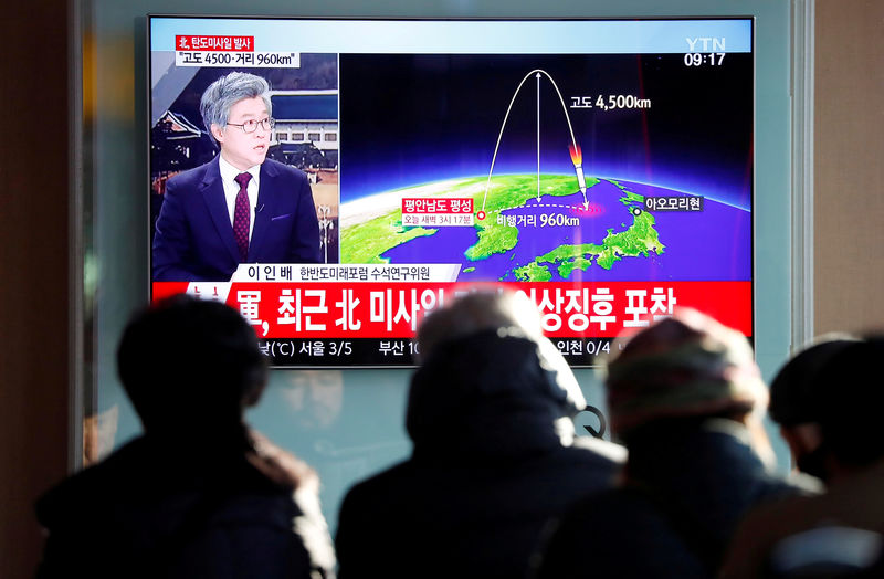 © Reuters. People watch a television broadcast of a news report in Seoul on North Korea firing what appeared to be an ICBM that landed close to Japan