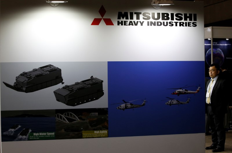 © Reuters. Visitor is seen at Mitsubishi Heavy Industries' booth during the MAST show in Chiba