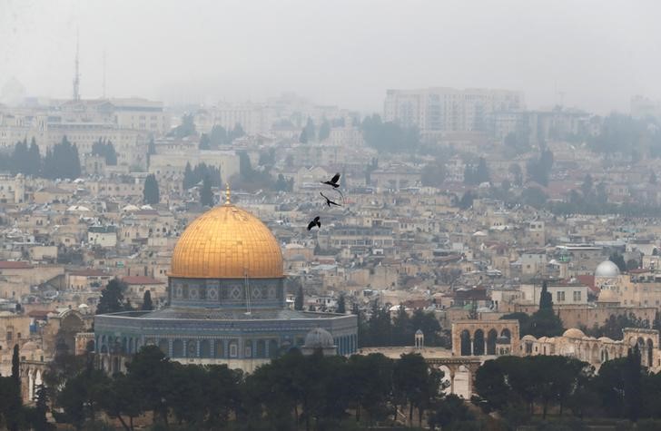 © Reuters. Birds fly on a foggy day near the Dome of the Rock, located in Jerusalem's Old City on the compound known to Muslims as Noble Sanctuary and to Jews as Temple Mount