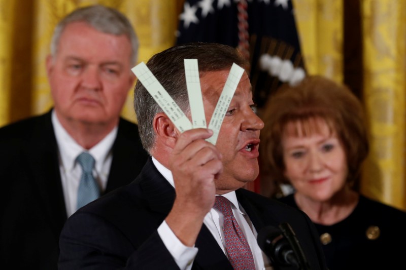 © Reuters. Shuster holds strips of paper used by air traffic controllers to keep track of planes during an event where Trump proposed reforms to the U.S. air traffic control system, at the White House in Washington