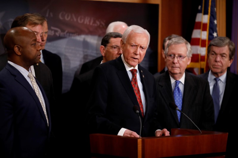 © Reuters. Sen. Orrin Hatch, accompanied by Senate Majority Leader Mitch McConnell and members of the Republican Conference, speaks at a news conference about the passage of the Tax Cuts and Jobs Acts at the U.S. Capitol in Washington