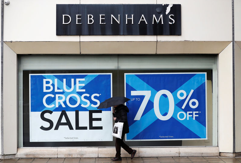 © Reuters. A person walks past a Debenhams store in Stockport
