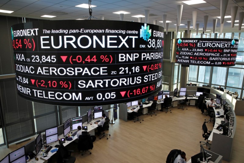 © Reuters. Company stock price information is displayed on screens as they hang above the Paris stock exchange, operated by Euronext NV, in La Defense business district in Paris