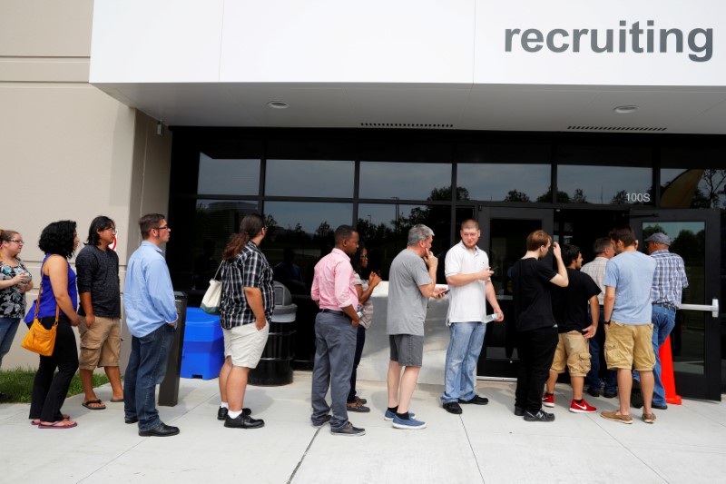 © Reuters. FILE PHOTO: Job seekers line up to apply during "Amazon Jobs Day" at the Amazon.com Fulfillment Center in Fall River