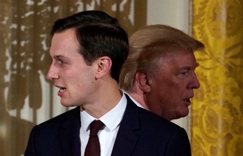 © Reuters. FILE PHOTO: U.S. President Donald Trump passes his adviser and son-in-law Jared Kushner during a Hanukkah Reception at the White House in Washington