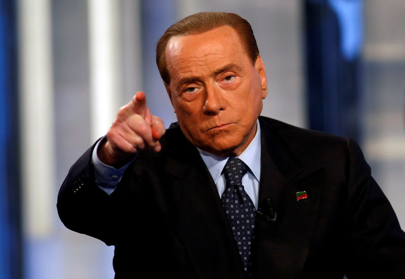 © Reuters. FILE PHOTO: Italy's former Prime Minister Silvio Berlusconi gestures as he attends television talk show "Porta a Porta" (Door to Door) in Rome