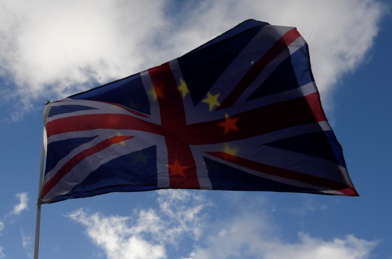 © Reuters. An EU flag and Union flag are seen flying together during an anti-Brexit protest near the Houses of Parliament in London