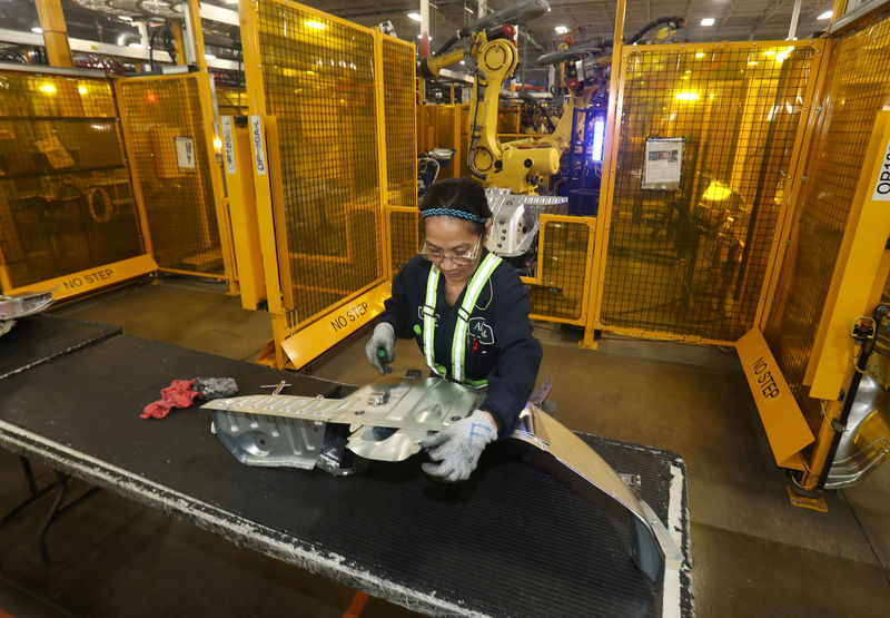 © Reuters. FILE PHOTO: Worker checks welded part from auto weld assembly line at Alfield Industries, a subsidiary of Martinrea