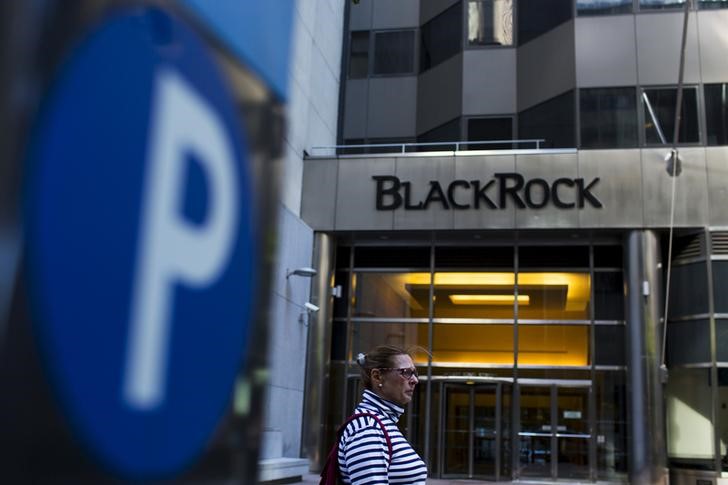 © Reuters. FILE PHOTO: A woman walks next to a BlackRock sign pictured in the Manhattan borough of New York