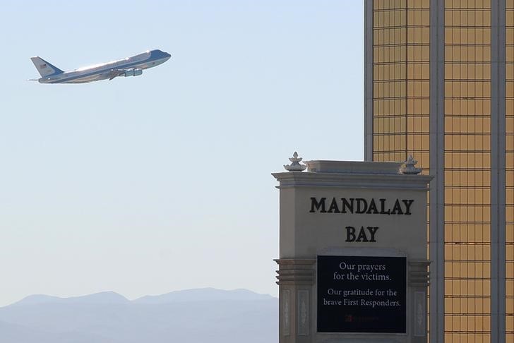 © Reuters. Air Force One departs Las Vegas past the a sign in front of Mandalay Bay hotel where shooter Stephen Paddock conducted his mass shooting along the Las Vegas Strip in Las Vegas