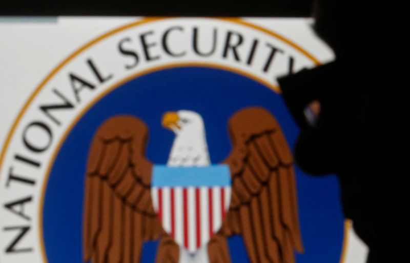 © Reuters. FILE PHOTO: A man is silhouetted near logo of the U.S. National Security Agency (NSA) in this photo illustration taken in Sarajevo