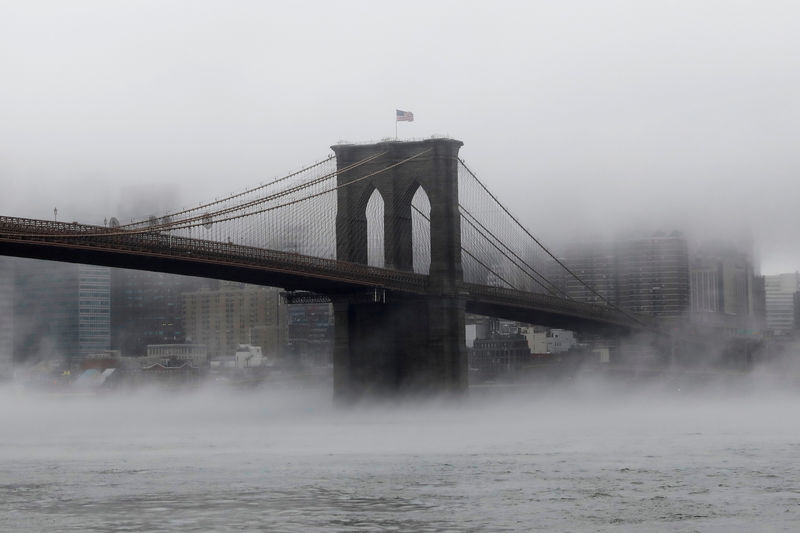 © Reuters. FILE PHOTO - The Brooklyn Bridge is seen partially in fog from in front of the Manhattan skyline in Brooklyn