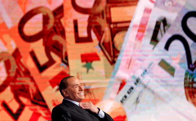 © Reuters. FILE PHOTO: Italy's former Prime Minister Berlusconi smiles during the taping of the television talk show "Porta a Porta" (Door to Door) in Rome