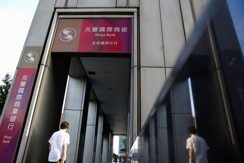 © Reuters. A man walks past a bureau of Mega International Commercial Bank in Taipei, Taiwan