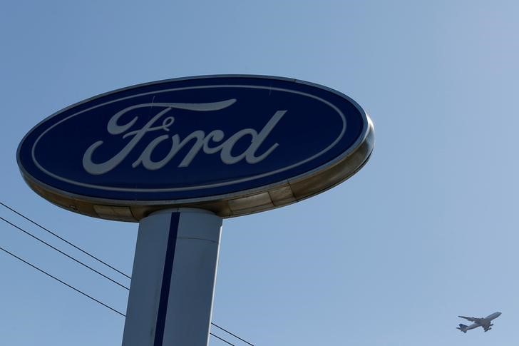 © Reuters. FILE PHOTO: An airplane flies above a Ford logo in Colma, California