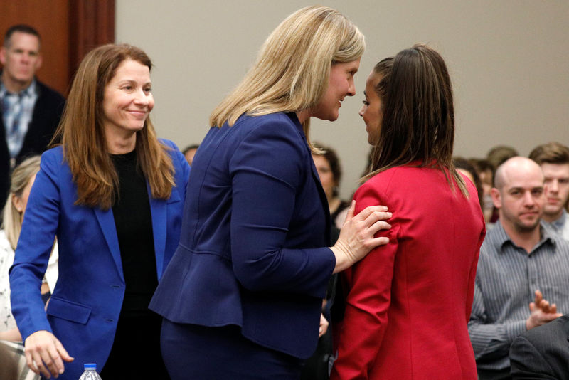 © Reuters. Victim and former gymnast Aly Raisman is greeted by prosecutor Angela Povilaitis after speaking at the sentencing hearing for Larry Nassar, a former team USA Gymnastics doctor who pleaded guilty in November 2017 to sexual assault charges, in Lansing