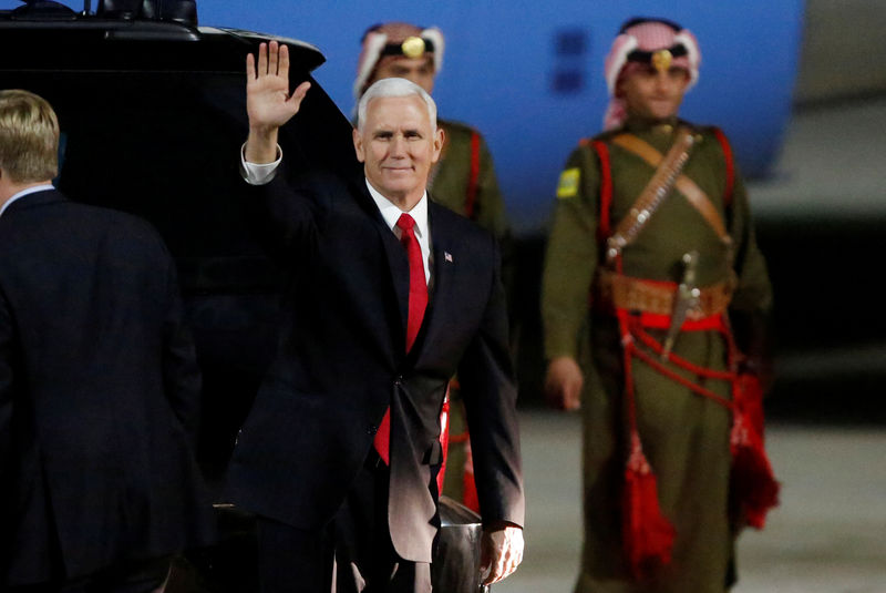 © Reuters. U.S. Vice President Mike Pence waves to the media after his arrival at Amman military airport