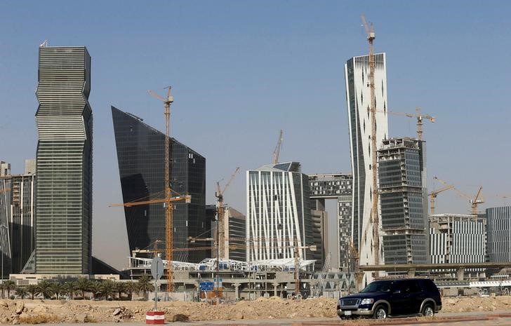 © Reuters. FILE PHOTO:A vehicle drives past the King Abdullah Financial District in Riyadh