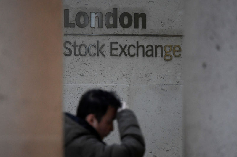 © Reuters. FILE PHOTO: People walk past the London Stock Exchange Group offices in the City of London, Britain