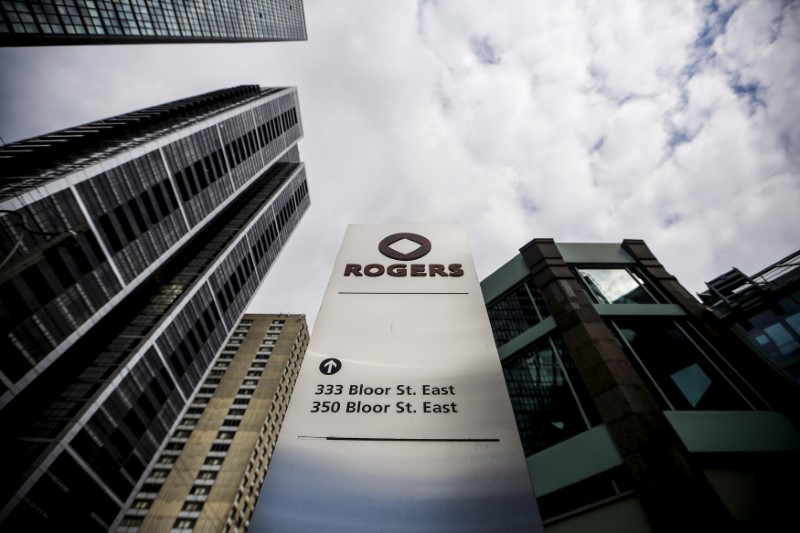 © Reuters. FILE PHOTO: A sign stands in front of Rogers Communications Inc. building on the day of their annual general meeting for shareholders in Toronto