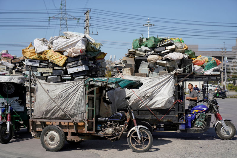 © Reuters. Tricycles carrying electronic waste are seen at the government-sponsored recycling park in the township of Guiyu