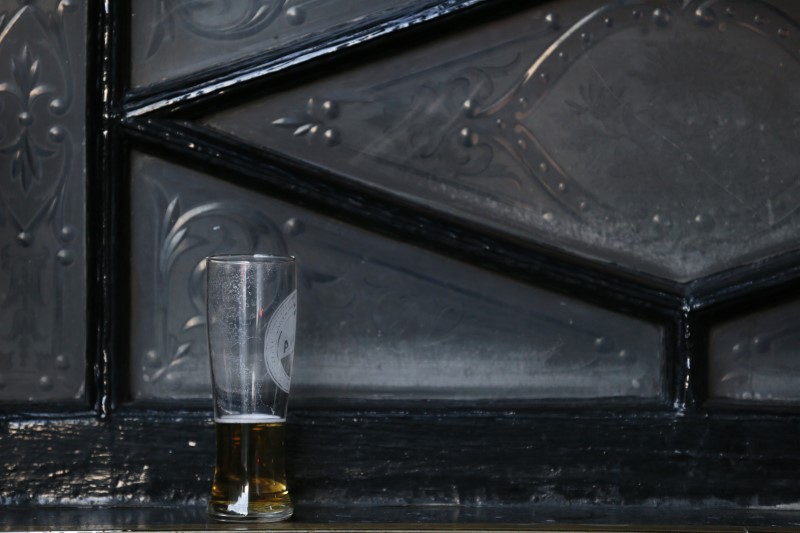 © Reuters. An unfinished pint of beer stands outside a pub in central London