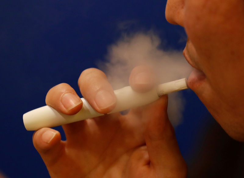 © Reuters. FILE PHOTO: A man smokes iQOS at a restaurant in Tokyo