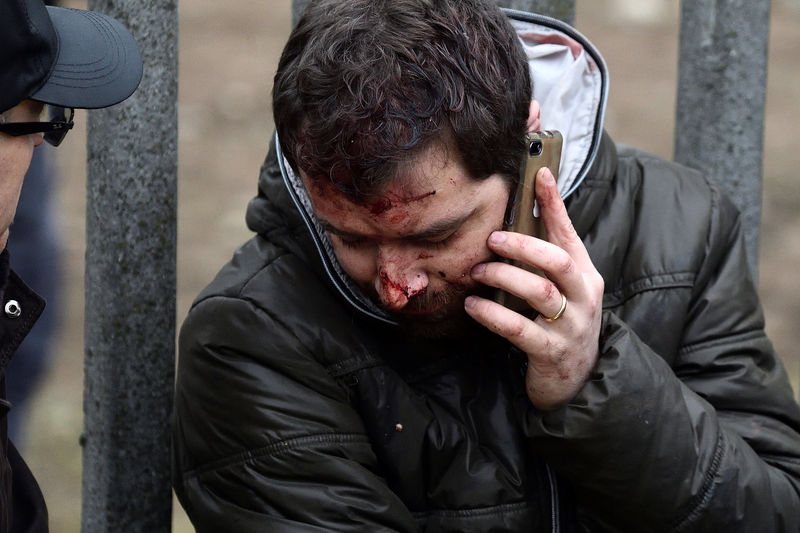© Reuters. An injured person makes a phone call after two trains derailed in Pioltello, on the outskirts of Milan