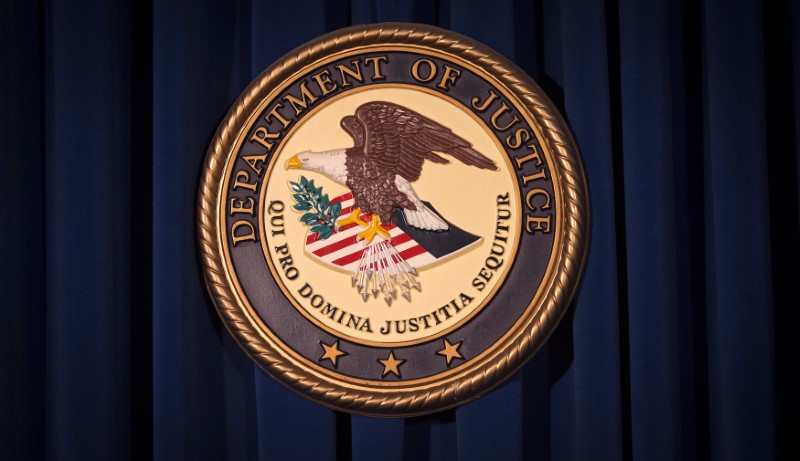 © Reuters. FILE PHOTO:The DOJ logo is pictured on a wall after a news conference in New York