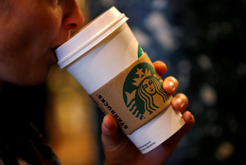 © Reuters. FILE PHOTO: A customer sips her coffee in Starbucks' Mayfair Vigo Street branch in central London