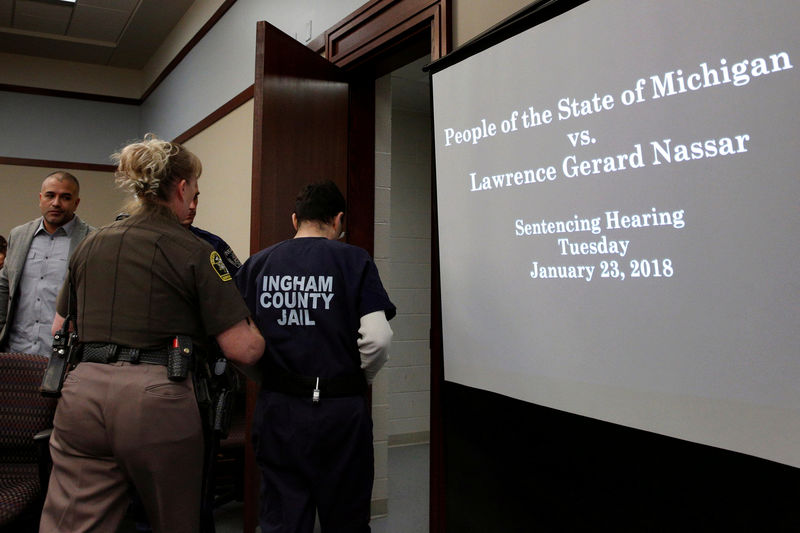 © Reuters. FILE PHOTO: Larry Nassar is led from the courtroom after listening to victim testimony during his sentencing hearing in Lansing Michigan