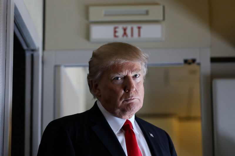 © Reuters. President Trump pauses as he talks to journalists who are members of the White House travel pool on board Air Force One during flight to Palm Beach, Florida