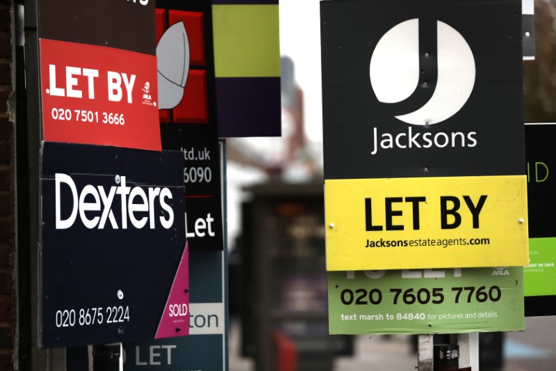 © Reuters. Estate agent boards on display in London