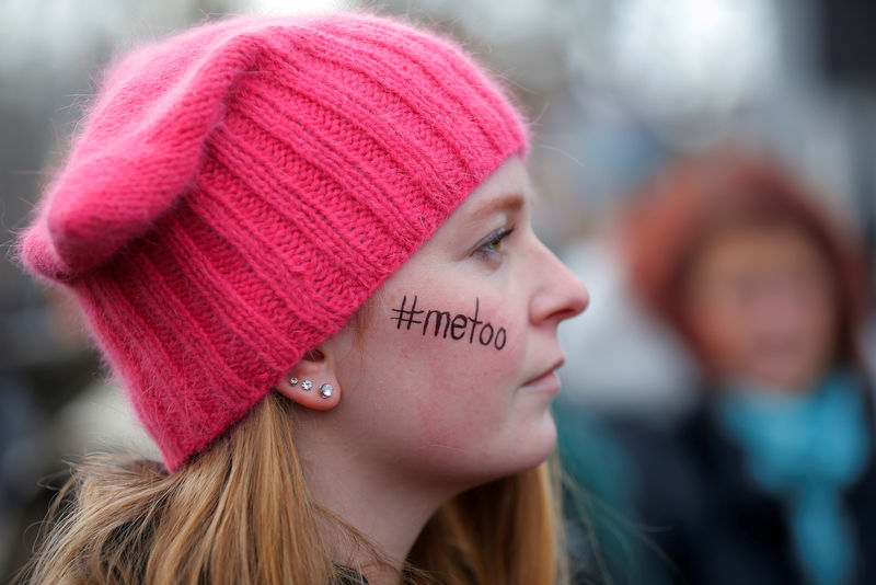 © Reuters. FILE PHOTO:    Caitlyn MacGregor, with "#metoo" written on her face and wearing a pink "pussyhat", attends the second annual Women's March in Cambridge