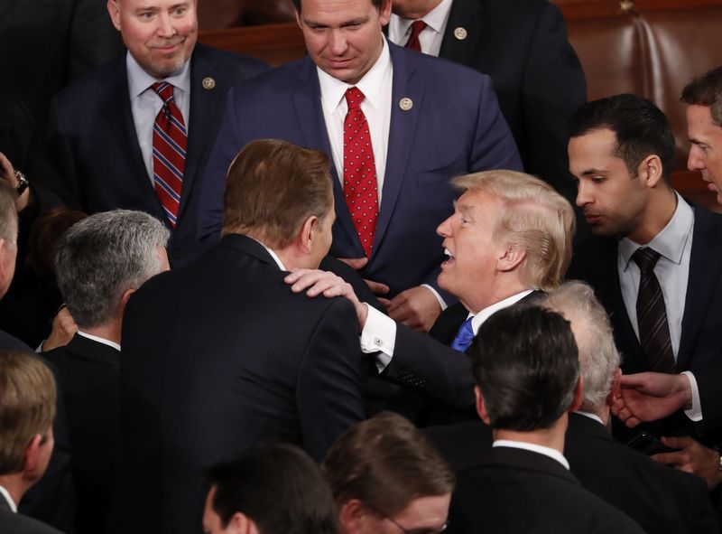 © Reuters. U.S. President Trump talks with members of Congress after delivering his State of the Union address in Washington