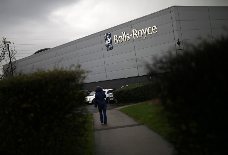 © Reuters. FILE PHOTO: A worker walks into a Rolls Royce site in Derby