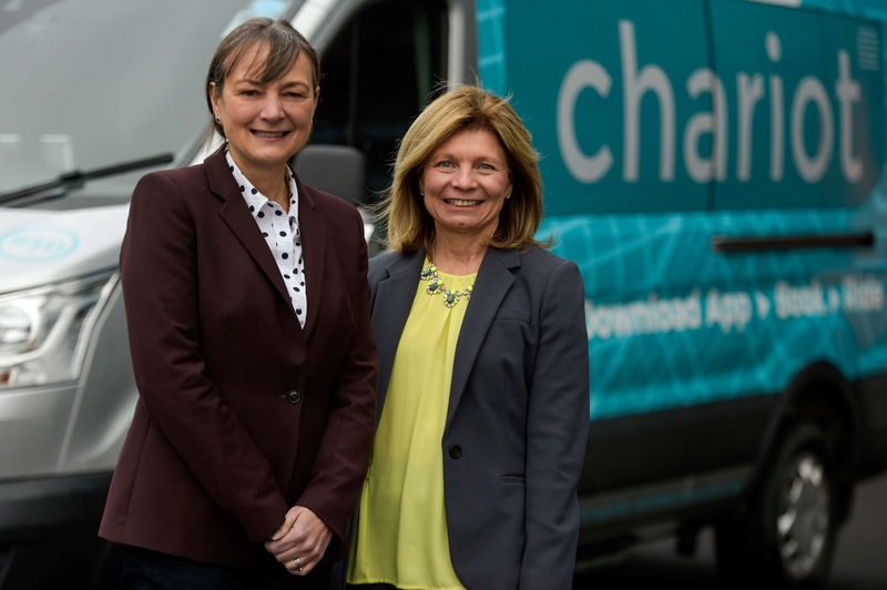 © Reuters. Sarah-Jayne Williams, Director of Smart Mobility, and Marcy Klevorn, President of Mobility at Ford, stand with a Ford Transit Chariot van in London